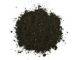 Heap of black humus soil over white